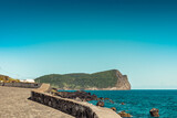 Fototapeta Morze - Seascape stone wall with Monte Brasil in the background, Terceira - Azores PORTUGAL
