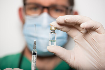 doctor holding covid - 19 coronavirus vaccine