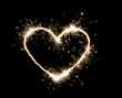 © New Africa - Bright sparkling heart contour on black background