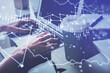 © peshkova - Double exposure of woman hands typing on computer and forex chart hologram drawing. Stock market invest concept.