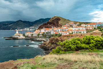 Aerial view of Quinta do Lorde smal village hotel on coast of the Portuguese island of Madeira with small yacht harbour