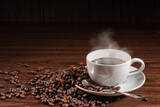Fototapeta Mapy - cup of smoky coffee with spoon on coffee beans