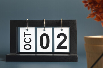 October 2, Date design with a black wooden calendar for a business, Date Plans to remind.