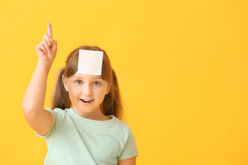 Sticker - Little girl with blank note paper on her forehead against color background