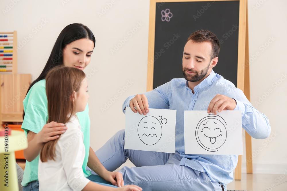 Male psychologist working with family in office
