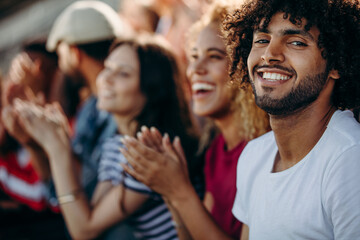 Man with friends watching a soccer match at stadium