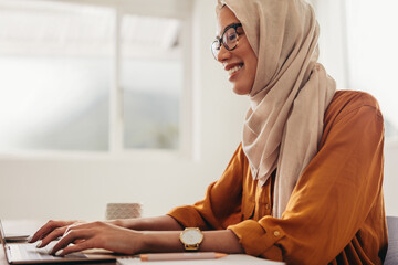 Wall Mural - Muslim business woman working from home