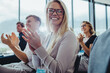 © Jacob Lund - Business people sitting at seminar clapping hands
