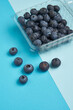 Creative layout made of blueberry on blue background. Flat lay. Food concept. Macro concept.