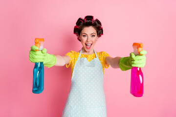 Wall Mural - Positive excited girl hold bottle chemical spray wear yellow dotted t-shirt green gloves isolated on pastel color background