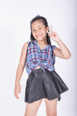 Portrait of cute casual smiling asian girl 8-9 year old posing and looking at camera isolated on light background. Laughing people. Positive emotions. Childhood concept.