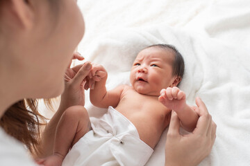 woman and new born boy relax. mother breast feeding baby. family at home. happy mother and baby. you