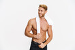 Happy caucasian shirtless man posing with towel and smiling