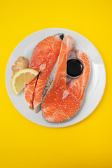 Wall Mural - fresh salmon with lemon, ginger and soy sauce on white plate