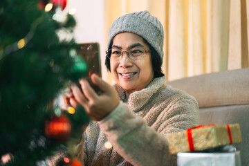 Wall Mural - Asian elder woman lifestyle with modern technology using mobile phone on christmas holidays