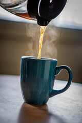 Poster - Man pouring tea into a mug from a teapot