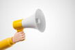 © Foxstudio - Cartoon hand in yellow jacket holding megaphone loudspeaker over white background.