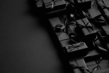 a pile various size black boxed gifts placed on stack. christmas concept.