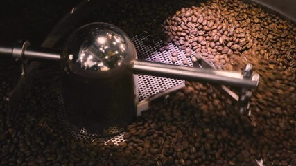 Poster - Production of fresh fried coffee beans roasting factory process. Prepared coffee beans mixing around on a cooling plate of an oven.