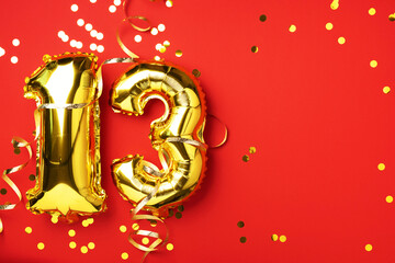 Gold foil balloon number, digit thirteen. Birthday greeting card, inscription 13. Anniversary celebration event. Banner. Stylish golden numeral, bright shiny glitter, red background. Numerical digit