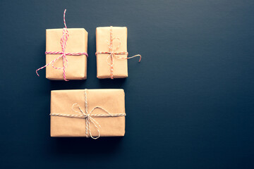 Wall Mural - brown gift box in diy style on dark background.giving and anniversary cocepts idea