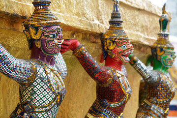 Wall Mural - demon statue which support golden pagoda