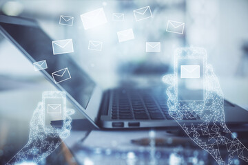 Desktop computer background in office and flying envelops hologram drawing. Double exposure. Electronic mail concept.
