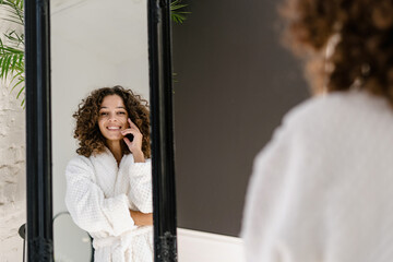 Wall Mural - Young african american woman in bathrobe at bathroom