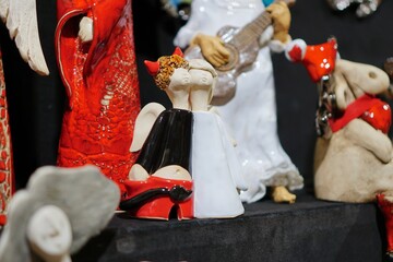 Decorative porcelain figures at Cracow Christmas market. Traditional market with handmade souvenirs, Krakow, Poland.   