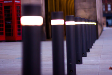 Row of black bollards with glow in the dark strips