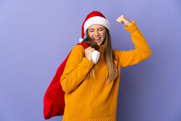 Wall Mural - Lithianian woman with christmas hat isolated on purple background doing strong gesture