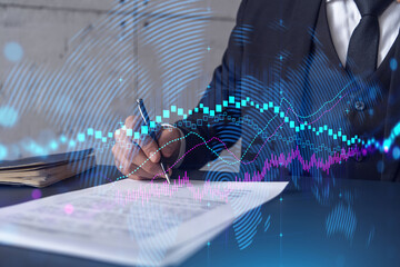 Businessman in suit signs contract. Double exposure with forex graph hologram. Man signing brokerage agreement. Financial market analysis and investment concept.