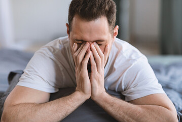 Aufkleber - Guy Rubbing Eyes Waking Up Sleepy Lying In Bed Indoor