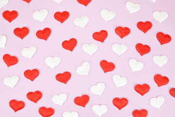 Canvas Print - Festive pattern of red and white decorative hearts on a pink background. Valentine's day concept.