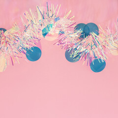 Wall Mural - christmas border. metallic tinsel garland, new year blue confetti on pastel pink background. copy sp