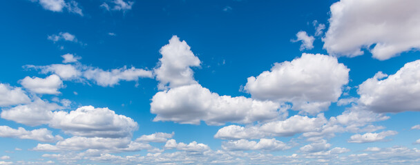 blue sky with puffy white clouds background-2