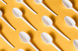 © Alex Salcedo/ADDICTIVE STOCK - Top view flat lay composition of disposable white plastic spoons for takeaway food arranged on yellow background