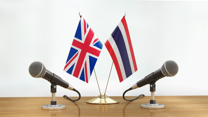 Wall Mural - Microphones and flags pair on a desk over defocused background