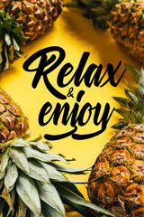 Sticker - selective focus of fresh ripe pineapples with green leaves on yellow background with relax and enjoy illustration