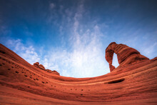 Low Angle View Of Delicate Arch In Arches National Park Against Cloudy Sky