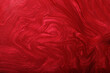 Red shimmer and glitter abstract background. Make up concept.Beautiful stains of liquid nail laquers.Fluid art,pour painting technique.Horizontal banner,can be used as backdrop for chat.