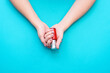 © Jane_S - Beautiful woman's hands on the blue background. Well-groomed female hands with a beautiful manicure in nude tones.