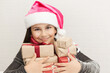 © kaganskaya115 - Happy smiling child girl Santa with Christmas boxes on white background