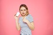 © SHOTPRIME STUDIO - Woman with a business card in her hands a striped T-shirt pink background Copy Space advertising
