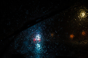 Wall Mural - poor visibility through wet windscreen while driving car on street in Moscow city in winter evening