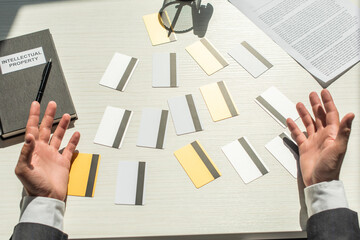 Wall Mural - Cropped view of businessman hands near credit cards on white textured background