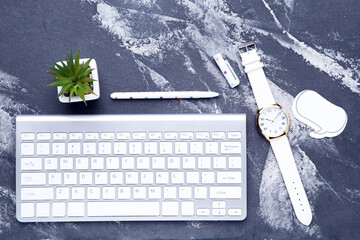 Wall Mural - Computer keyboard with green plant, wrist watch and speech bubble on wooden table