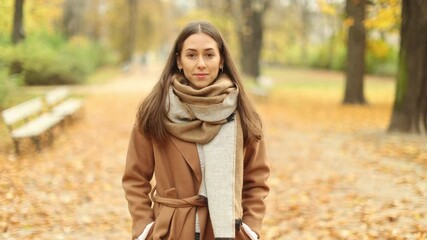 Wall Mural - smiling beautiful young woman enjoy autumn in a public park