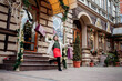 © volody10 - Happy girl holds paperbags with symbol of sale in the stores with sales at Christmas, around the city. Concept of shopping, holidays, happiness, Christmas Sales.