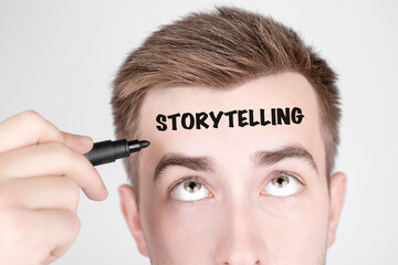 Aufkleber - Businessman with black marker writes the word Storytelling on his forehead